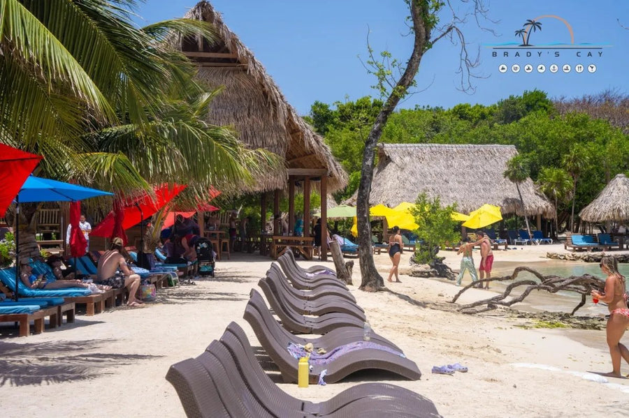 Colorful umbrellas and loungers on the beach at Brady's Cay, Roatán